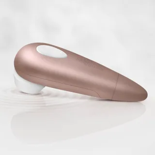 Satisfyer 1 Next Generation rose doré posé sur le côté, embout de succion blanc visible