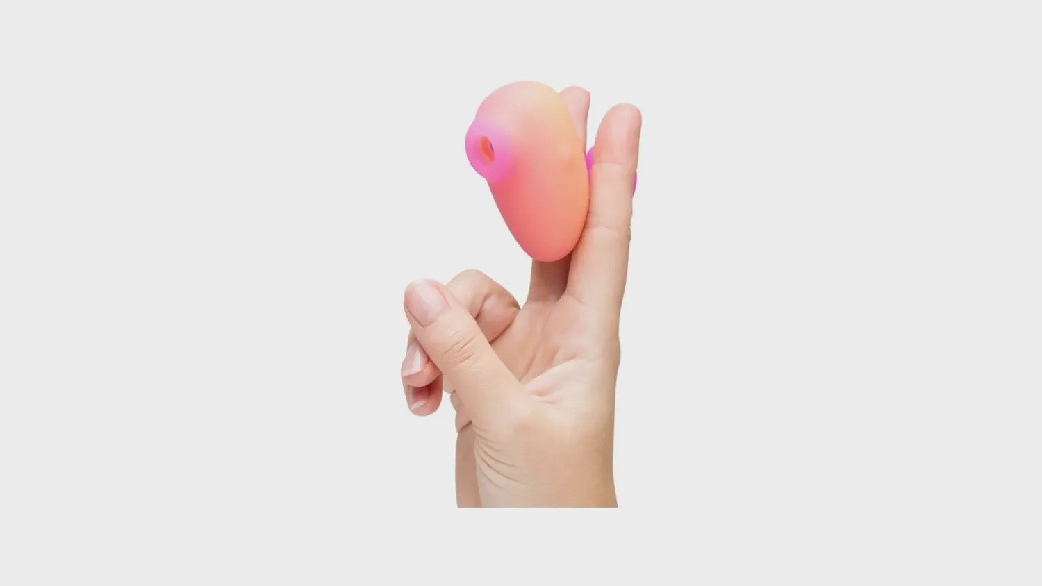 Stimulateur clitoridien à air pulsé Kiss de Romp, galet compact à tenir entre deux doigts