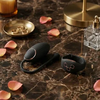 Œuf vibrant en silicone avec sa télécommande posé sur un tissu clair