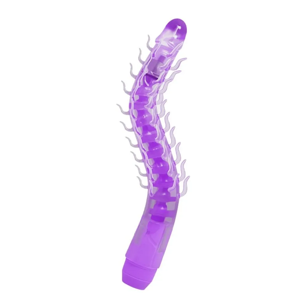 Vibromasseur violet en silicone flexible avec nervures en relief sur toute la longueur, tête arrondie et base cylindrique, sur fond blanc