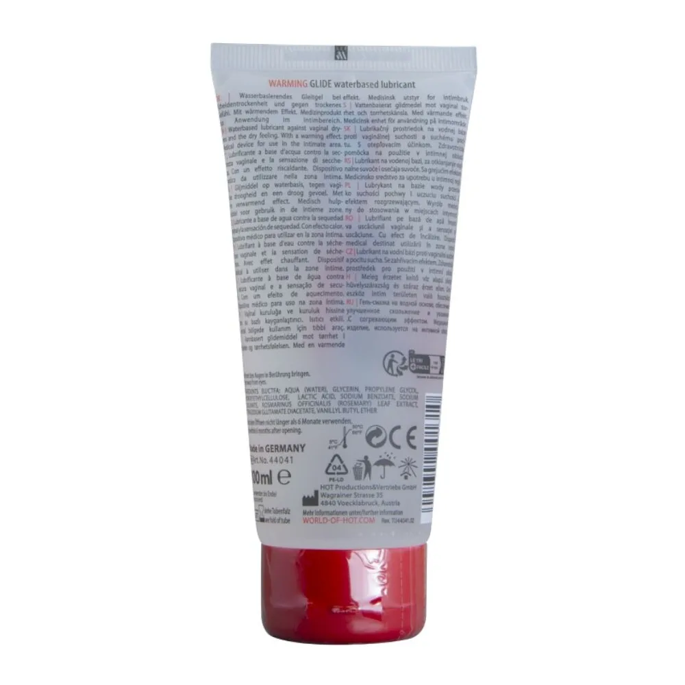 Tube translucide de lubrifiant à base d'eau avec capuchon rouge, étiquette blanche et rouge affichant « Warming Glide » et « HOT », contenance 100 ml