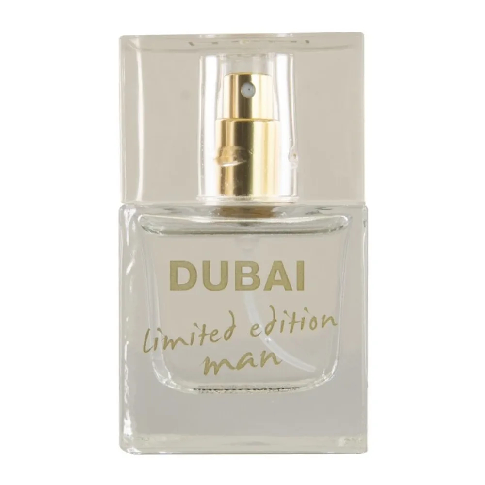Flacon de parfum aux phéromones Dubai limited edition man, verre transparent avec bouchon vaporisateur doré, liquide incolore, étiquette gravée en lettres dorées