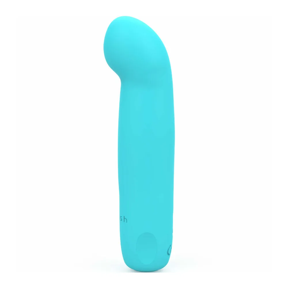 Vibromasseur en silicone jaune fluo avec extrémité arrondie et incurvée, corps lisse et allongé, fond blanc