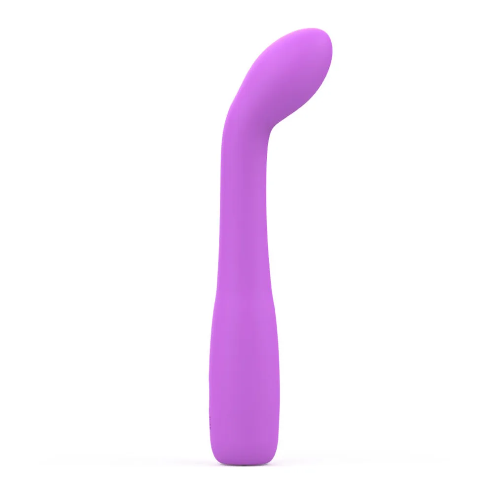 Vibromasseur en silicone rose fuchsia, forme incurvée avec embout arrondi, corps allongé effilé, sur fond blanc