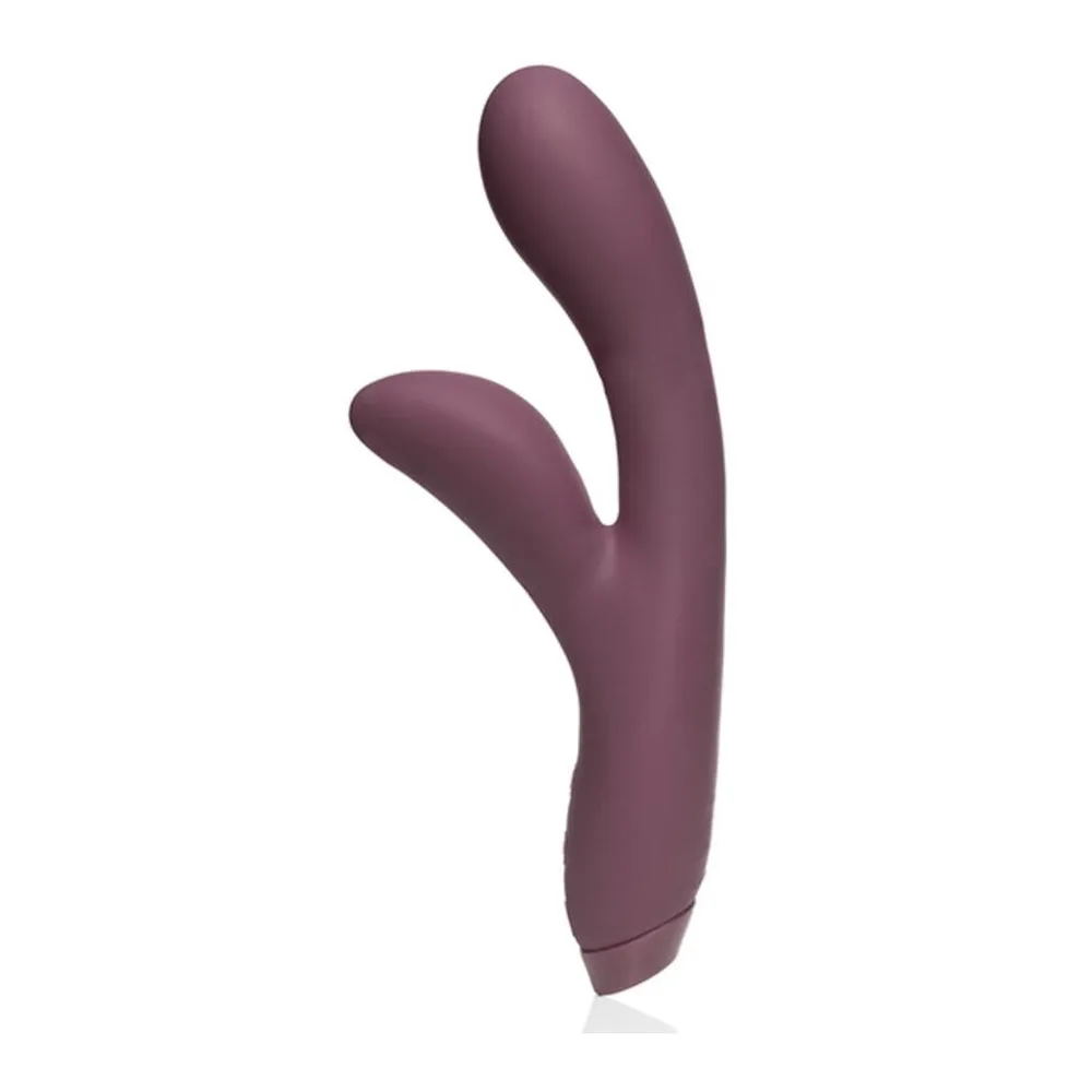 Vibromasseur rabbit en silicone aubergine, avec une tige courbe et deux bras arrondis, sur fond blanc