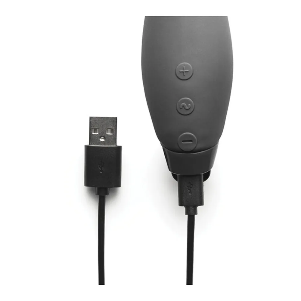 Vibromasseur rabbit noir en silicone avec tige incurvée flexible et deux branches écartées, sur fond blanc