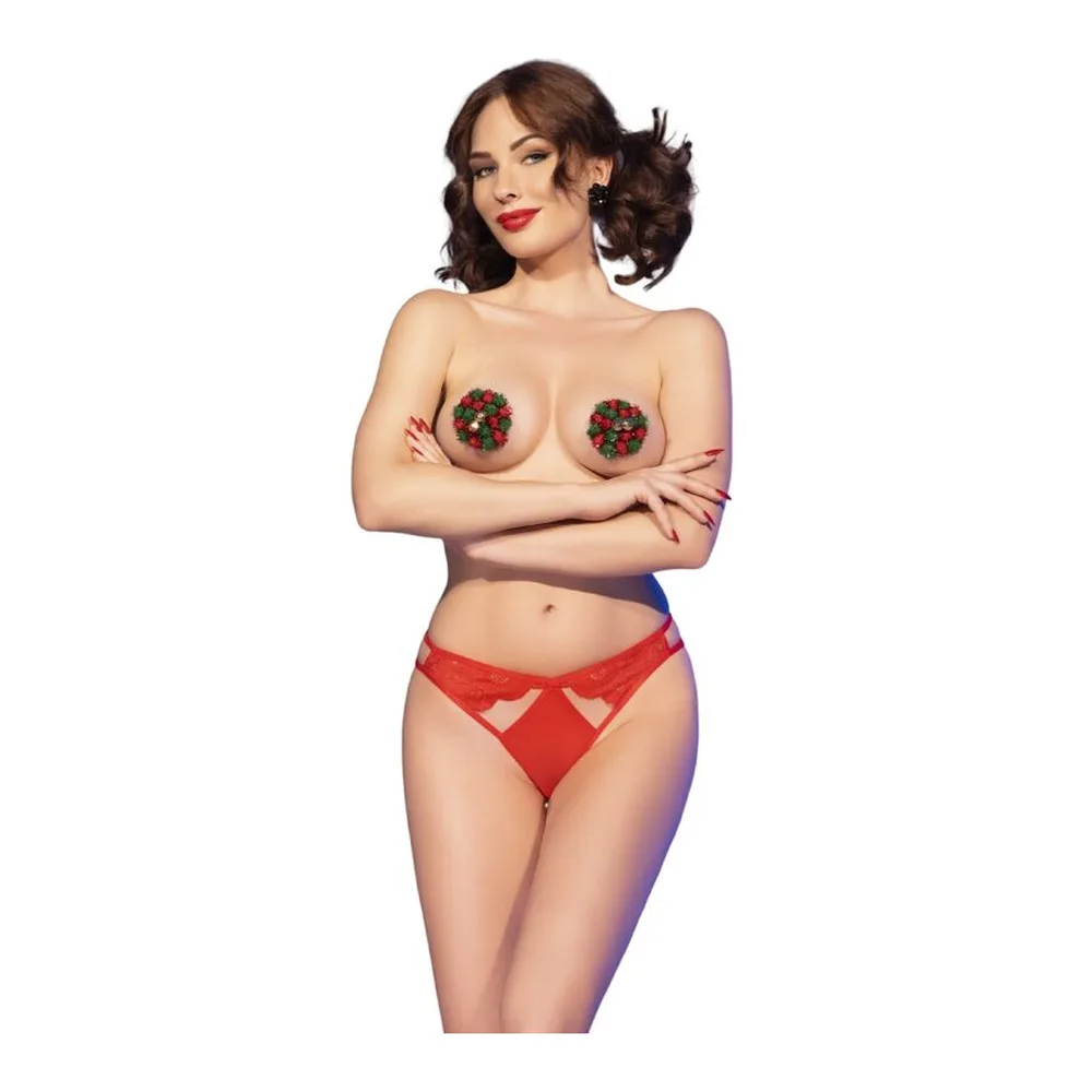 Ensemble de déguisement composé de cache-tétons rouges ornés de pompons et clochettes, accompagnés d'une culotte rouge à découpes, porté sur fond blanc