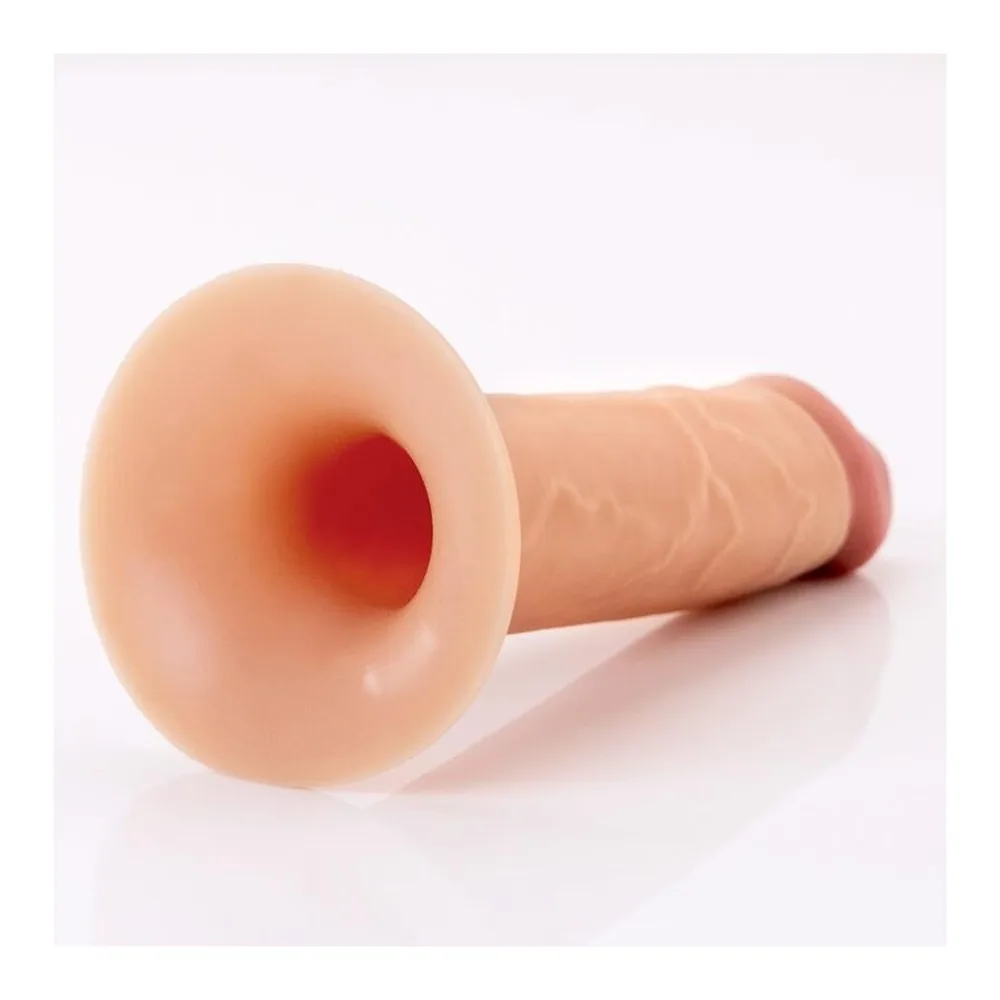 Gode-ceinture en silicone beige clair, de forme réaliste, attaché à un harnais noir réglable avec boucles et anneau métallique