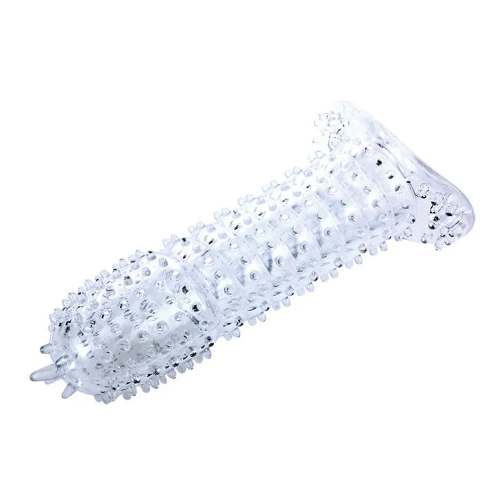 Gaine pénienne en silicone transparent hérissée de picots en relief sur toute la surface, base élargie avec ouverture centrale, sur fond blanc
