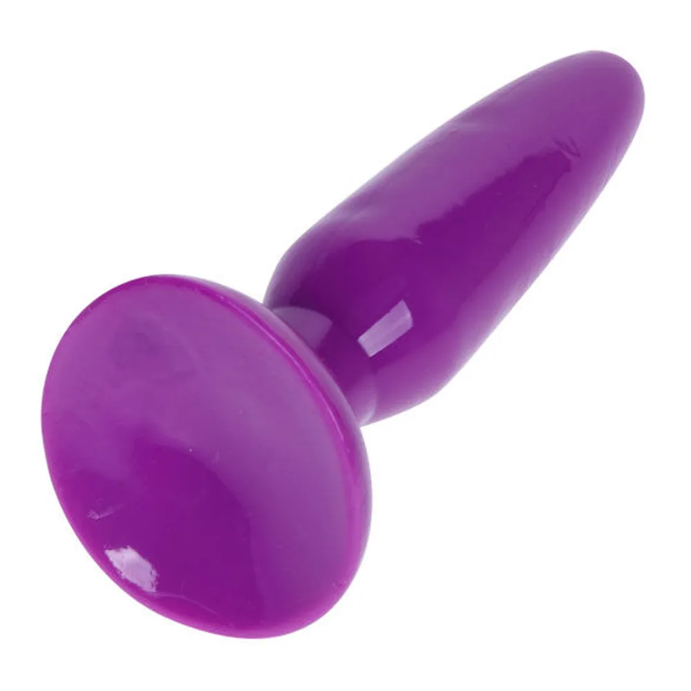 Petit plug anal en silicone violet brillant, forme effilée avec base ventouse aplatie, sur fond blanc