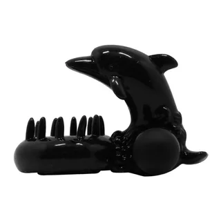 Stimulateur clitoridien noir en silicone en forme de dauphin, avec anneau pénien intégré et picots de stimulation, sur fond blanc
