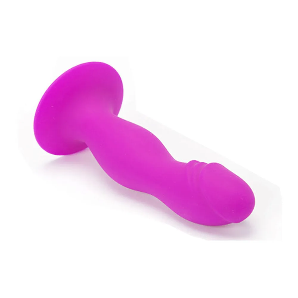 Plug anal en silicone rose fuchsia, forme réaliste avec gland marqué et base ventouse, sur fond blanc