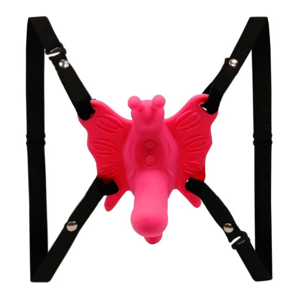Harnais papillon en silicone rose vif avec sangles noires ajustables et télécommande rose associée, sur fond blanc