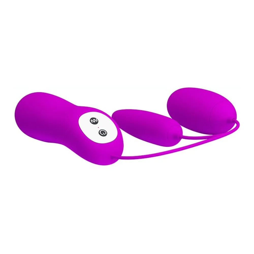 Œuf vibrant violet avec deux œufs reliés par un câble à un boîtier de commande violet doté de deux boutons, sur fond blanc