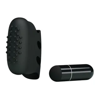 Vibromasseur noir en silicone avec picots en relief sur la face avant et deux orifices latéraux, accompagné d'une batterie cylindrique noire