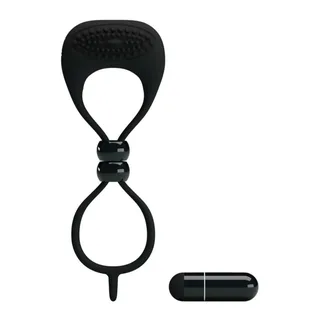 Cockring noir en silicone avec double anneau et boucle de serrage ajustable, accompagné d'une batterie cylindrique
