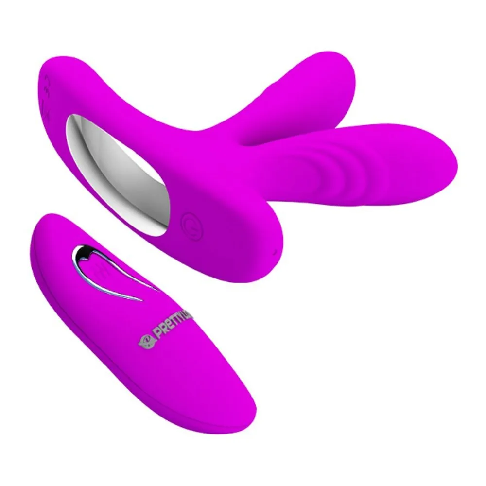 Stimulateur doigt en silicone magenta avec deux branches relevées et une base large pour le port au doigt, sur fond blanc