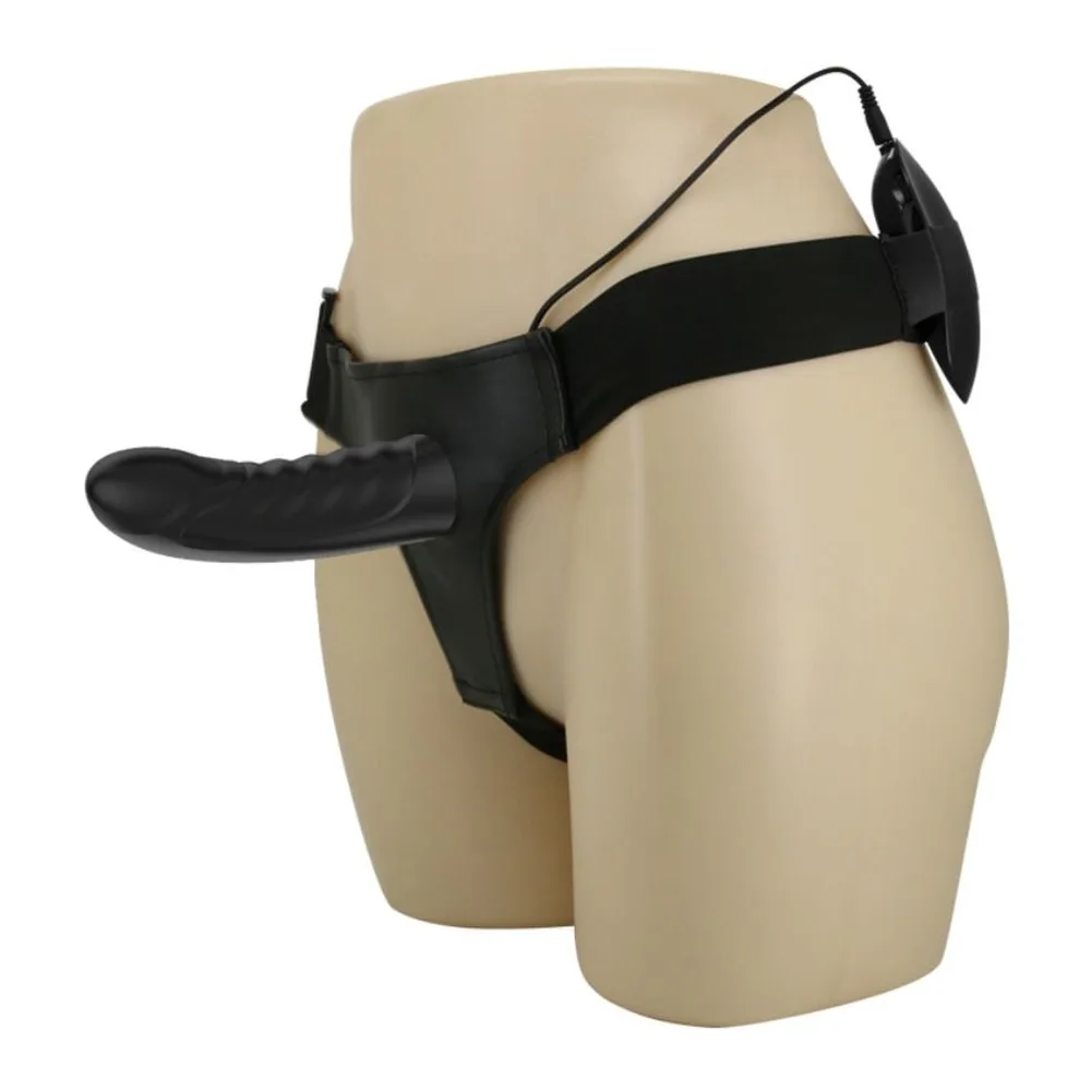 Gode-ceinture noir avec harnais ajustable affichant un insert creux vibrant, présenté sur mannequin neutre de couleur beige