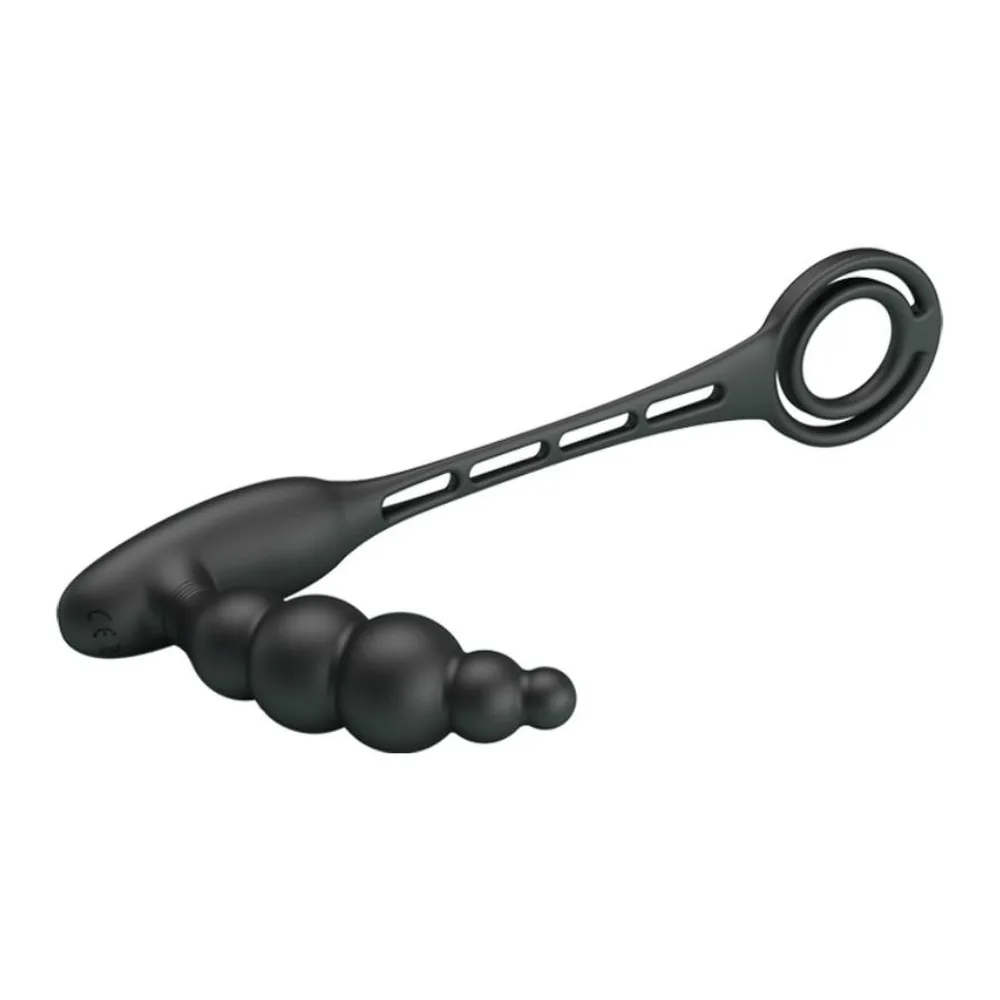 Anneau pénien noir en silicone relié par une sangle à un plug anal perlé vibrant, sur fond blanc