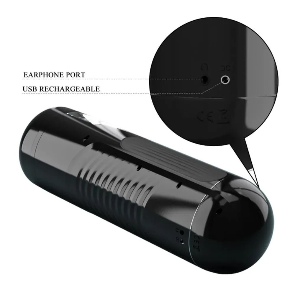 Masturbateur noir cylindrique avec détails en relief, port pour écouteurs et port USB de recharge visibles sur le schéma technique annoté