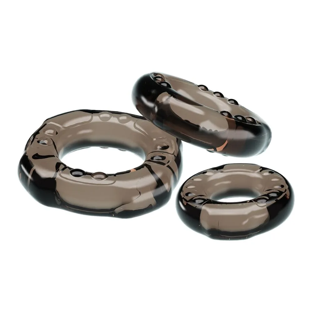 Trois anneaux extensibles en silicone noir, de tailles progressives, avec des picots en relief sur la surface, présentés alignés sur fond blanc