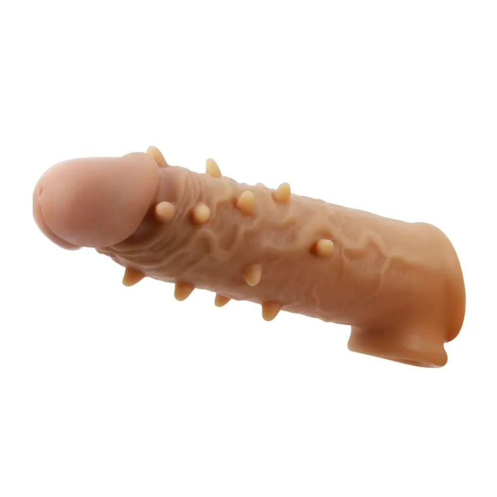 Gaine extensible en silicone beige chair, surface hérissée de picots, avec anneau testiculaire intégré et ouverture évasée