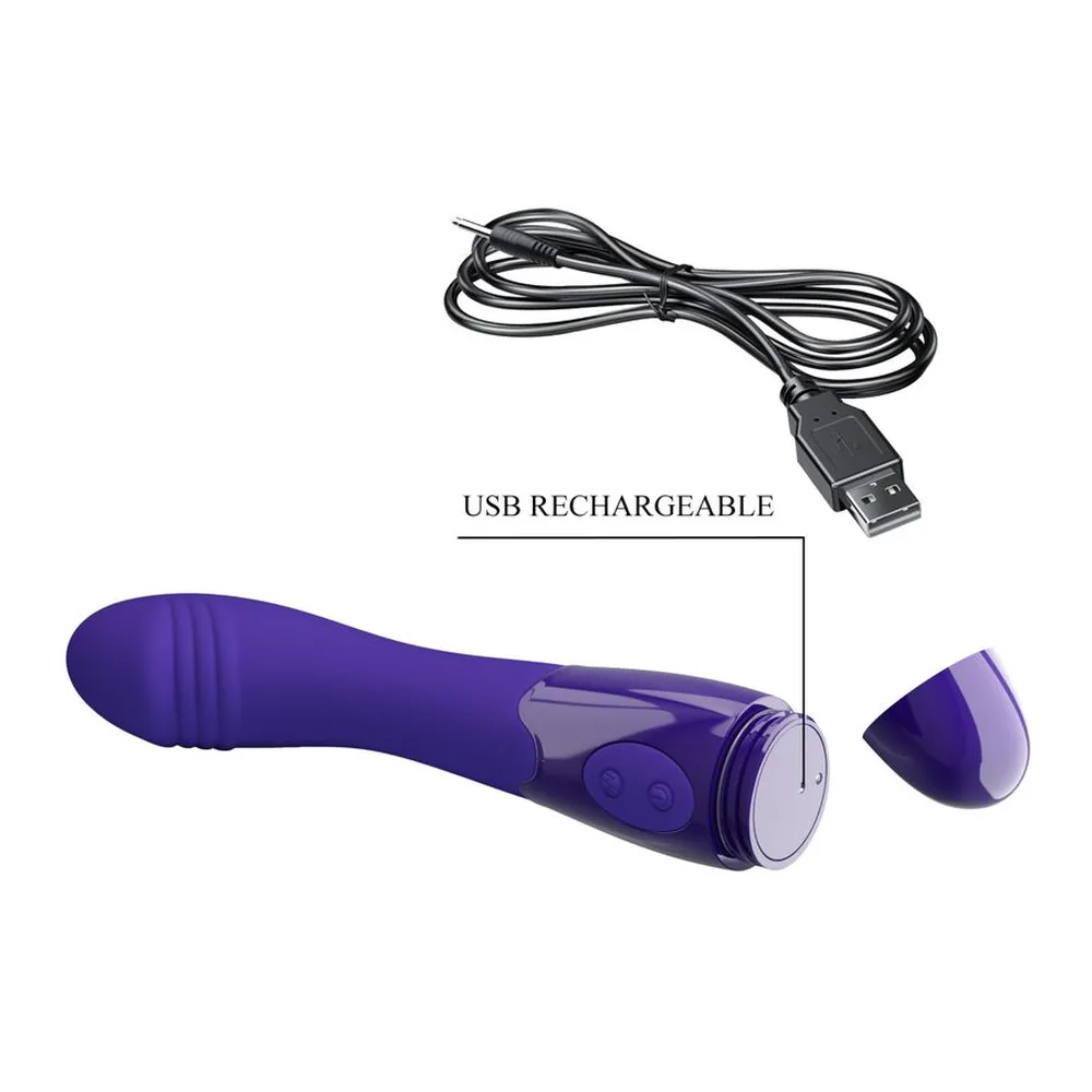 Emballage d'un vibromasseur en silicone violet foncé avec capuchon en cœur doré, boîte blanche et violette ornée de motifs floraux