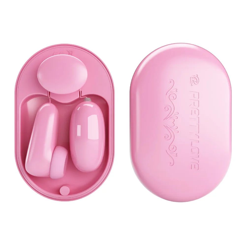 Ensemble rose composé d'une balle vibrante avec boîtier de rangement rond, d'un stimulateur en forme de galet et de sa télécommande filaire, sur fond blanc