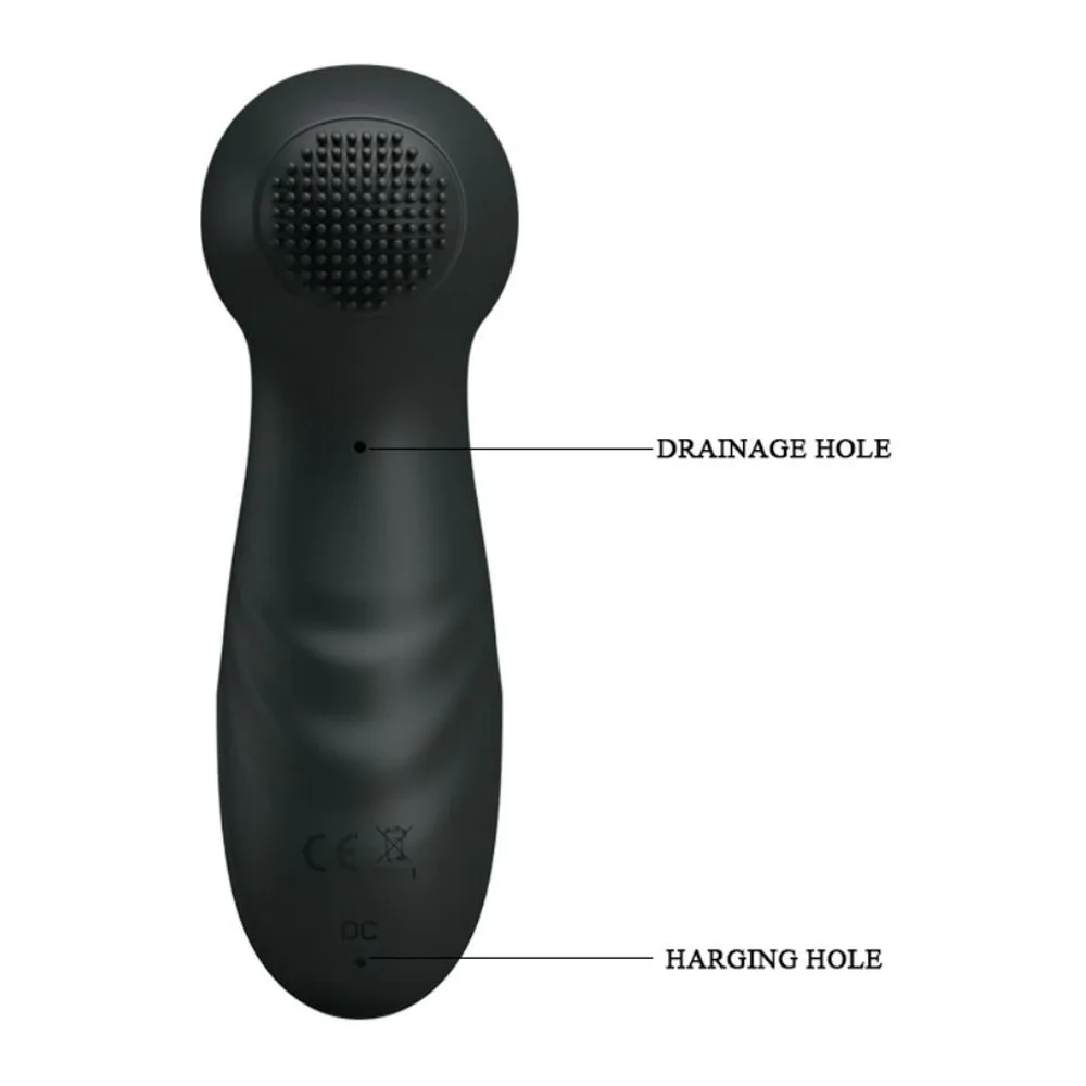 Stimulateur clitoridien noir en silicone avec embout arrondi, quatre boutons de commande (nettoyage, marche/arrêt aspiration, aspiration, vibration) et détails dorés à la base, sur fond blanc avec schéma technique