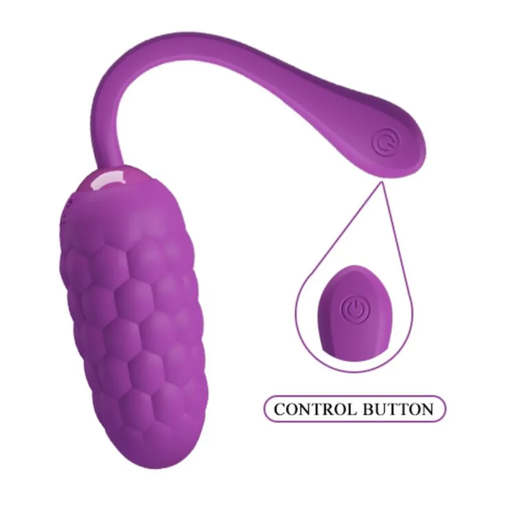 Œuf vibrant en silicone violet avec surface texturée et manche allongé, accompagné d'un cercle montrant le port de charge USB