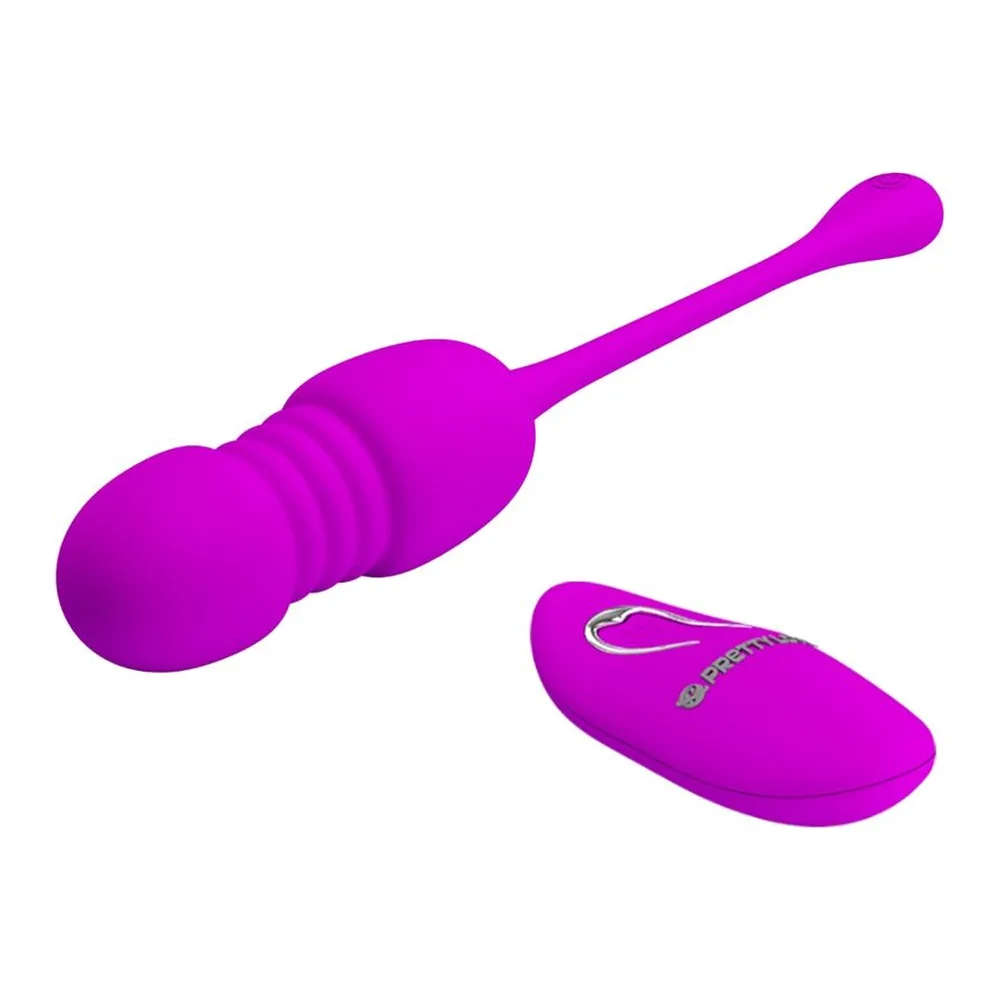 Œuf vibrant magenta avec poignée prolongée et œuf de contrôle à distance sans fil sur fond blanc