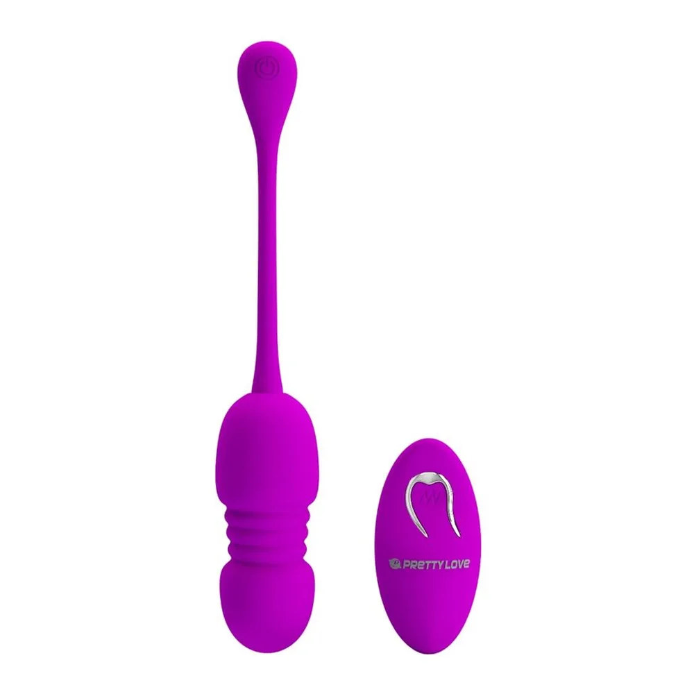 Œuf vibrant magenta avec poignée prolongée et œuf de contrôle à distance sans fil sur fond blanc
