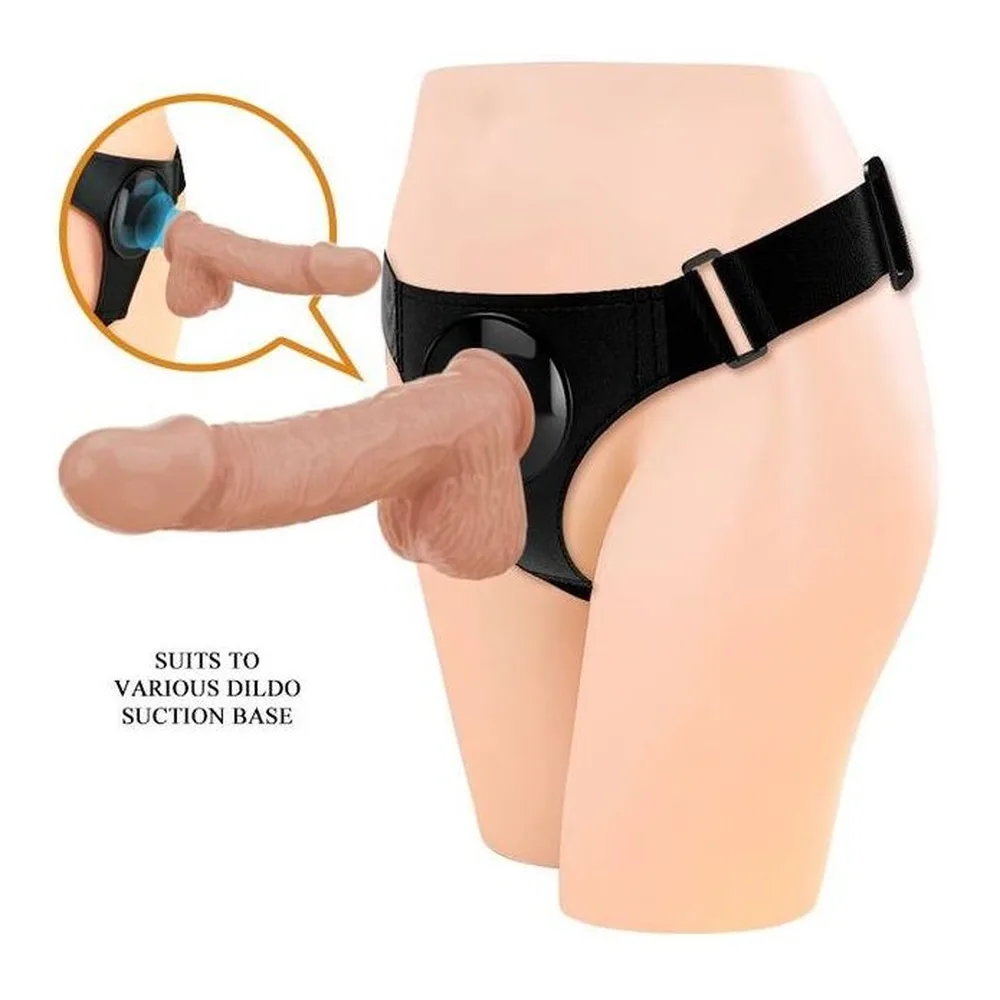 Slip harnais noir extensible avec gode réaliste en silicone, système de fixation par sangle ajustable, détail du clip de maintien en incrustation