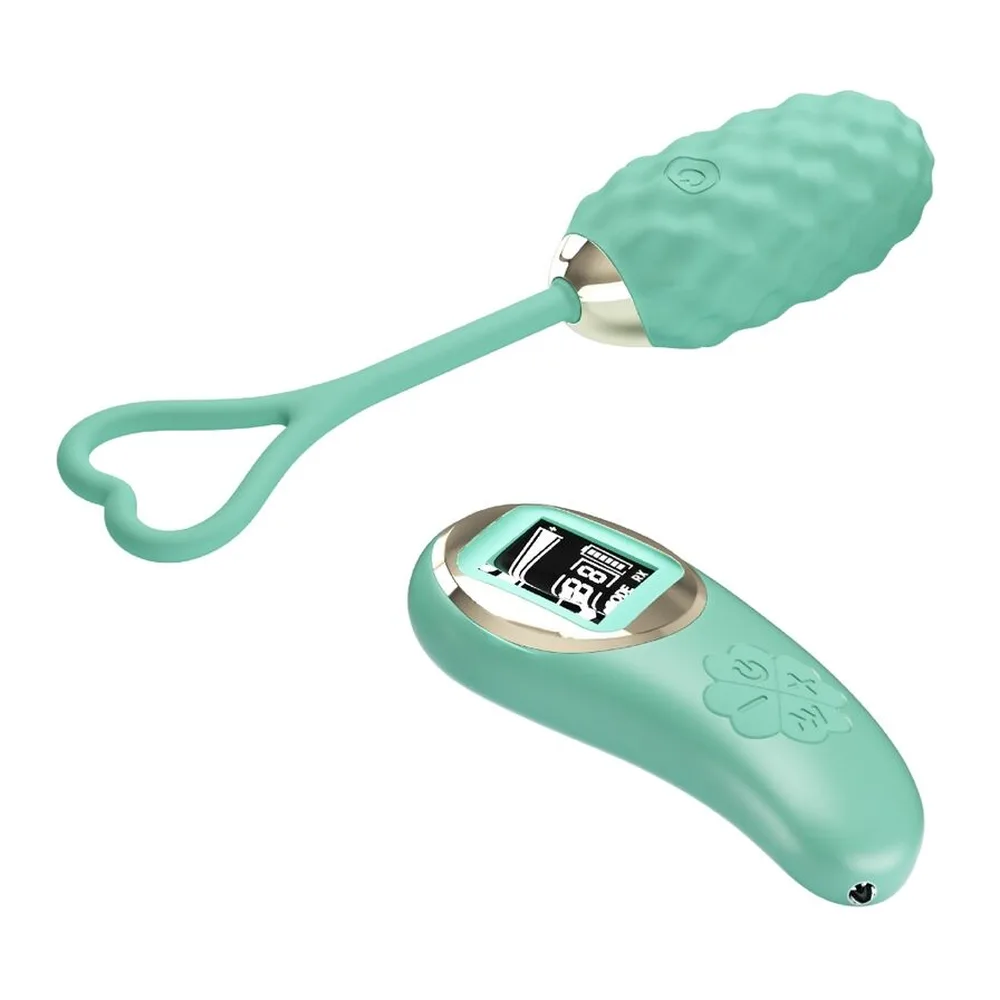 Œuf vibrant vert menthe avec anneau de retrait en forme de cœur, corps texturé en relief, accompagné d'une télécommande verte affichant écran LED numérique et modes de contrôle