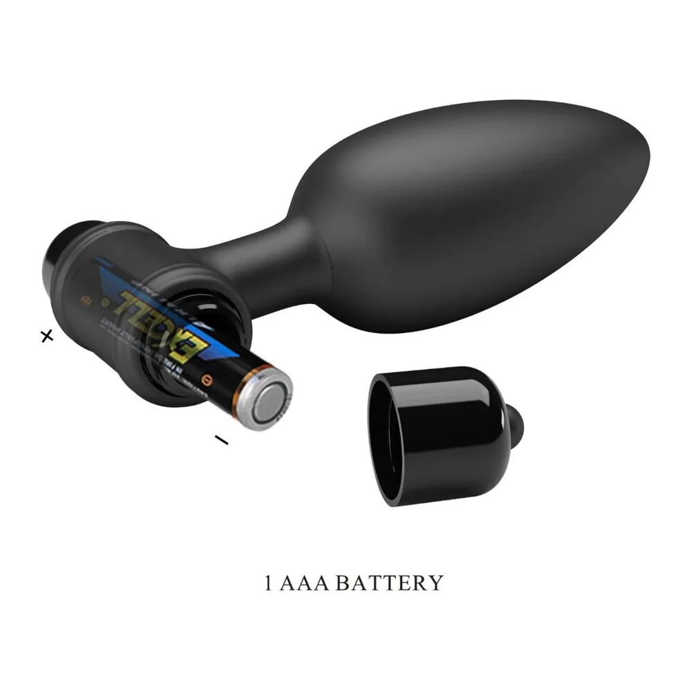 Plug anal noir en silicone avec base bulbeuse, module vibrant amovible montrant ses contrôles et compartiment à batterie AAA, sur fond blanc