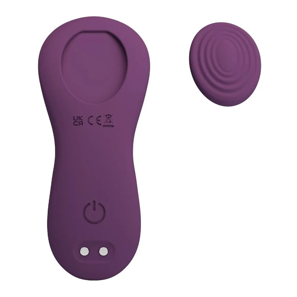 Stimulateur clitoridien violet mauve en silicone avec tête circulaire concave, bouton marche/arrêt et deux boutons de commande, accompagné d'une tête de rechange texturée