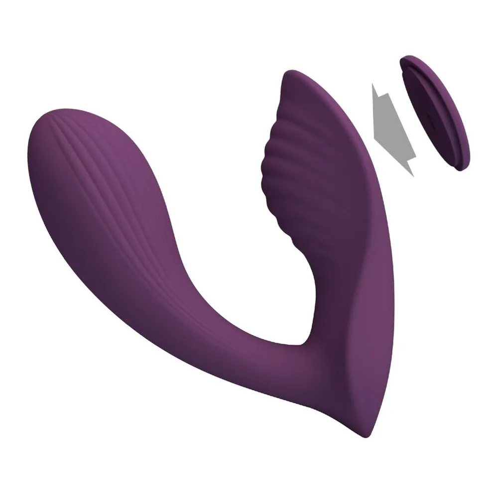 Masseur vibrateur en silicone mauve avec télécommande intégrée, bouton marche/arrêt et deux boutons de contrôle, motifs concentriques en relief sur la tête