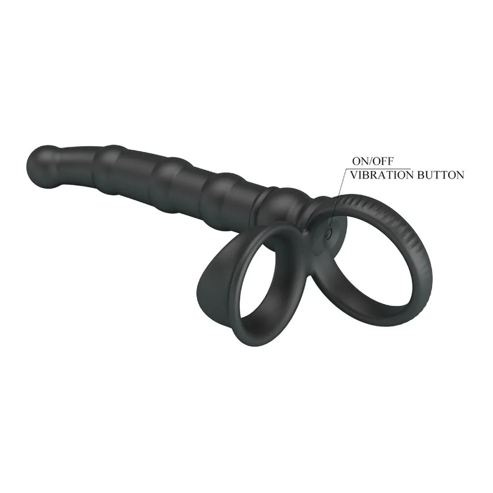 Anneau pénien noir avec plug anal intégré, en silicone, segment texturé à la base et deux anneaux souples côte à côte sur fond blanc