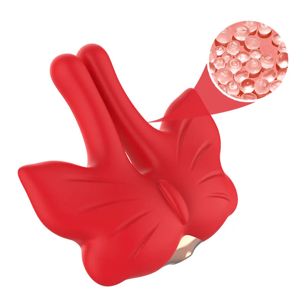 Pinces tétons rouges en silicone avec têtes magnétiques texturées, reliées par chaîne à un boîtier cœur rouge, détail agrandi montrant la surface perlée d'une tête magnétique