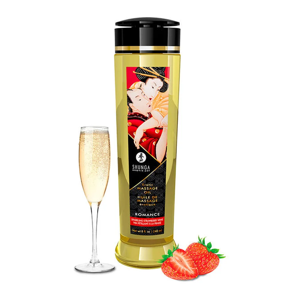 Flacon transparent d'huile de massage Shunga Romance jaune citron, étiquette noire avec illustration de couple, accompagné d'un verre de champagne et de fraises fraîches