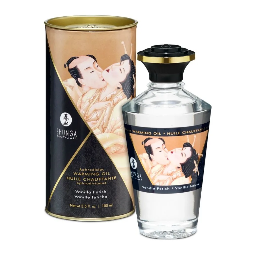 Huile de massage chauffante Shunga Vanilla Fetish en emballage : flacon transparent de 100 ml avec bouchon noir et doré, étiquette illustrée de personnages, accompagné de son étui cylindrique noir et or