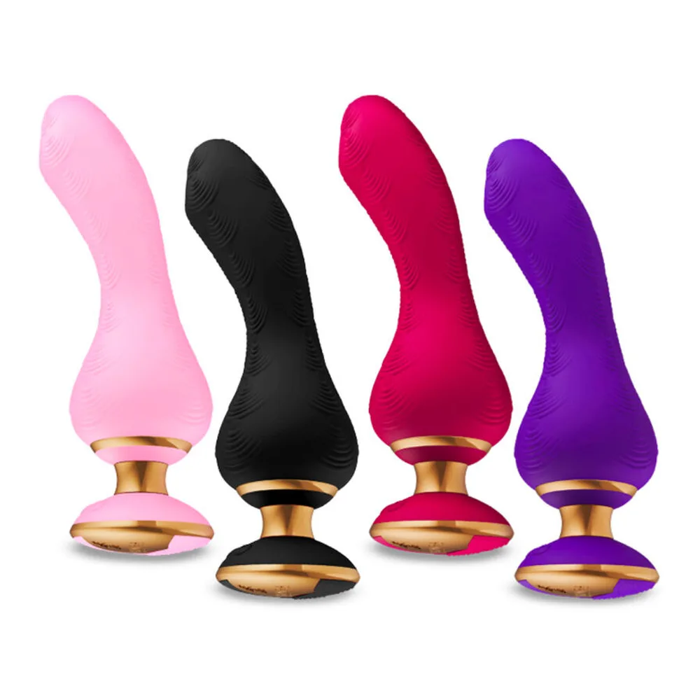 Vibromasseur rose vif avec embout flexible ondulé et base dorée circulaire, sur fond blanc