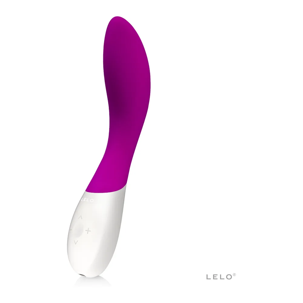 Vibromasseur point G Mona Wave en silicone rose magenta avec corps blanc, présenté à côté d'un nuage de poudre rose et bleu
