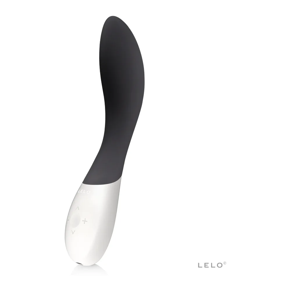 Vibromasseur point G Mona Wave en silicone rose magenta avec corps blanc, présenté à côté d'un nuage de poudre rose et bleu