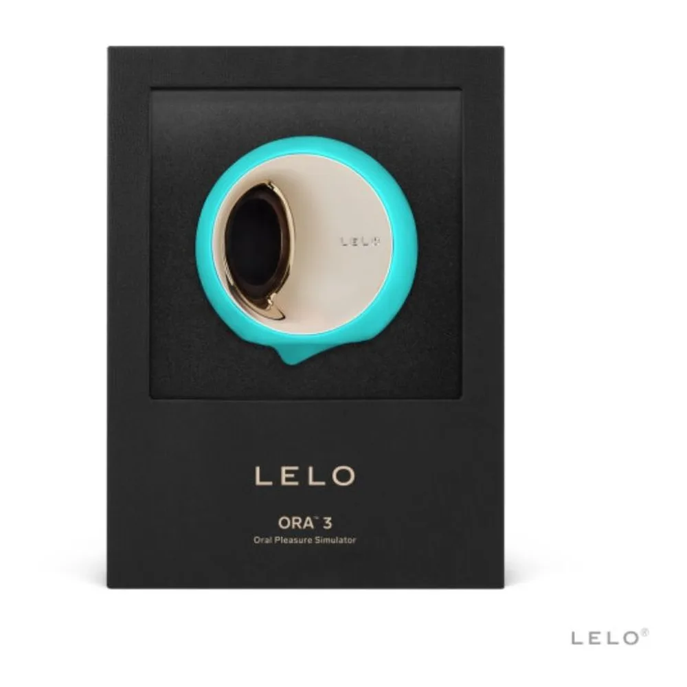 Stimulateur clitoridien Ora 3 en silicone turquoise et blanc crème avec anneau métallique doré, formes arrondies et organiques