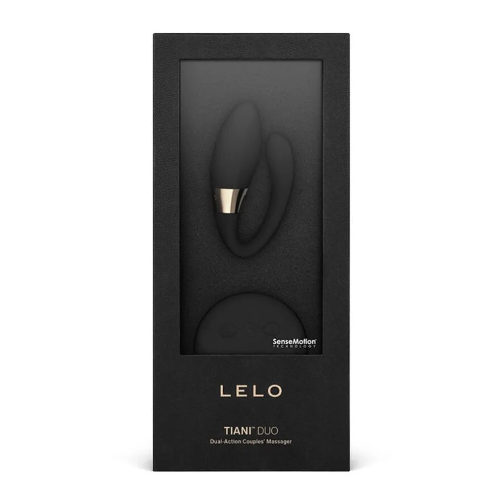Stimulateur clitoridien noir en silicone avec deux embouts courbes, l'un pointu et l'autre arrondi, séparés par une bande dorée, sur fond blanc