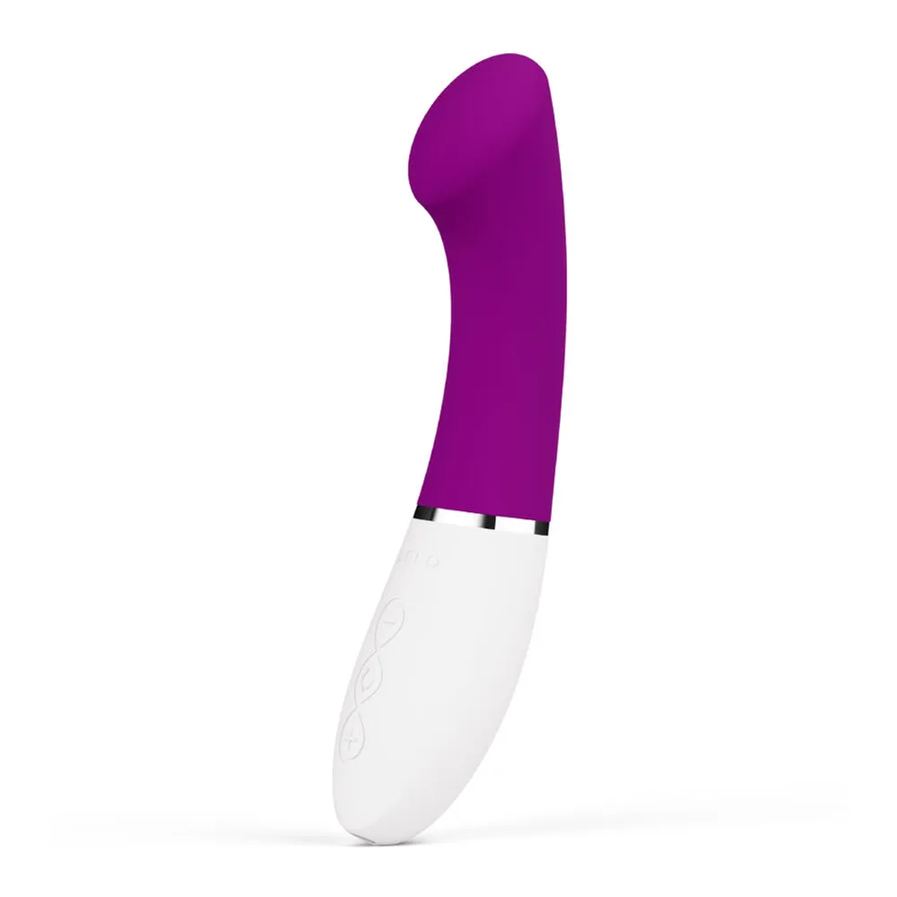 Vibromasseur point G au design ergonomique avec extrémité plate biseautée en silicone violet et manche blanc texturé, sur fond blanc
