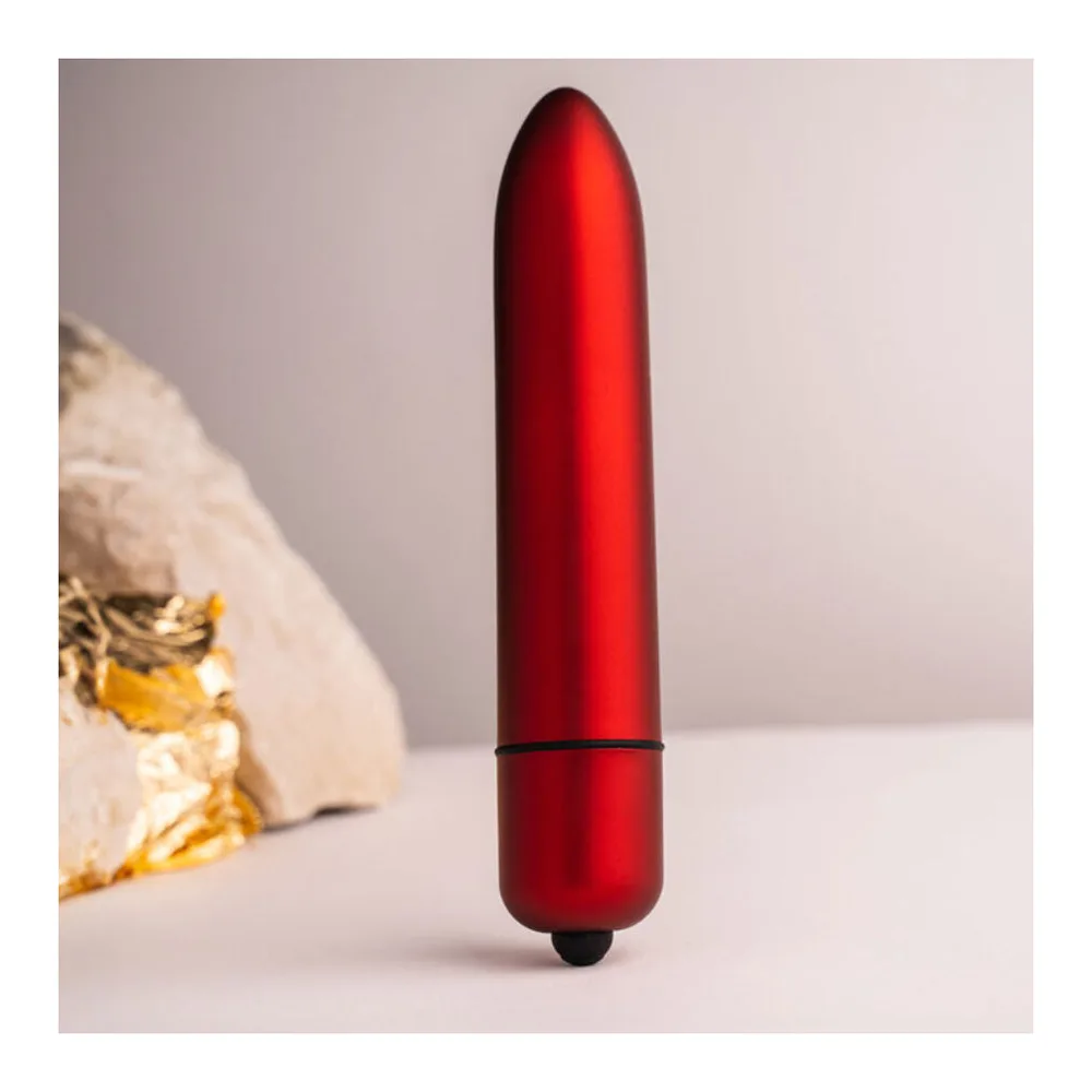 Stimulateur clitoridien en silicone rouge brillant, de forme arrondie et allongée, avec une bande noire de commande au tiers inférieur, sur fond blanc