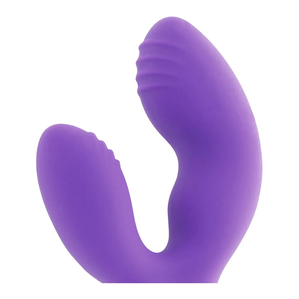 Vibromasseur en silicone violet avec deux branches souples et poignée beige, sur fond blanc