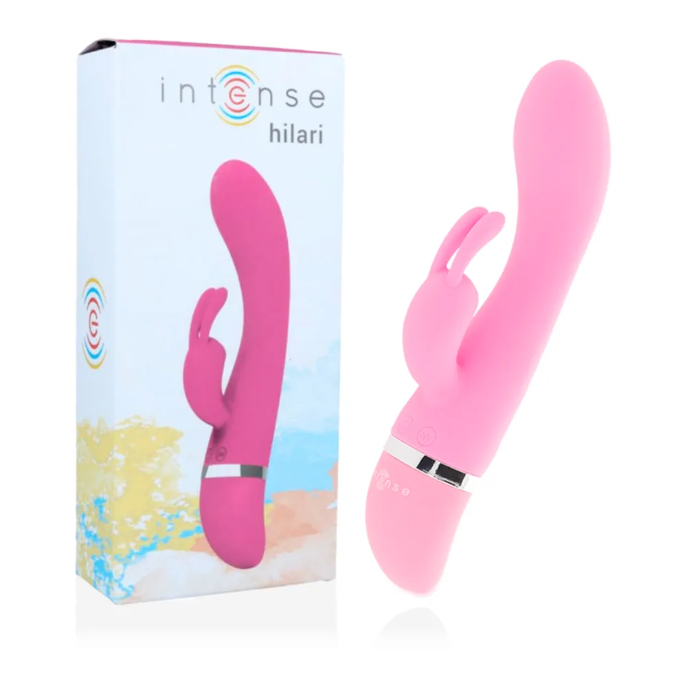 Emballage blanc et rose du vibrateur Intense Hilari, montrant le produit rose vif avec bras stimulateur, sur fond de plage colorée